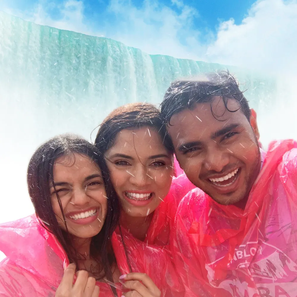 Friends taking selfie on Niagara City Cruises with Horseshoe Falls behind them