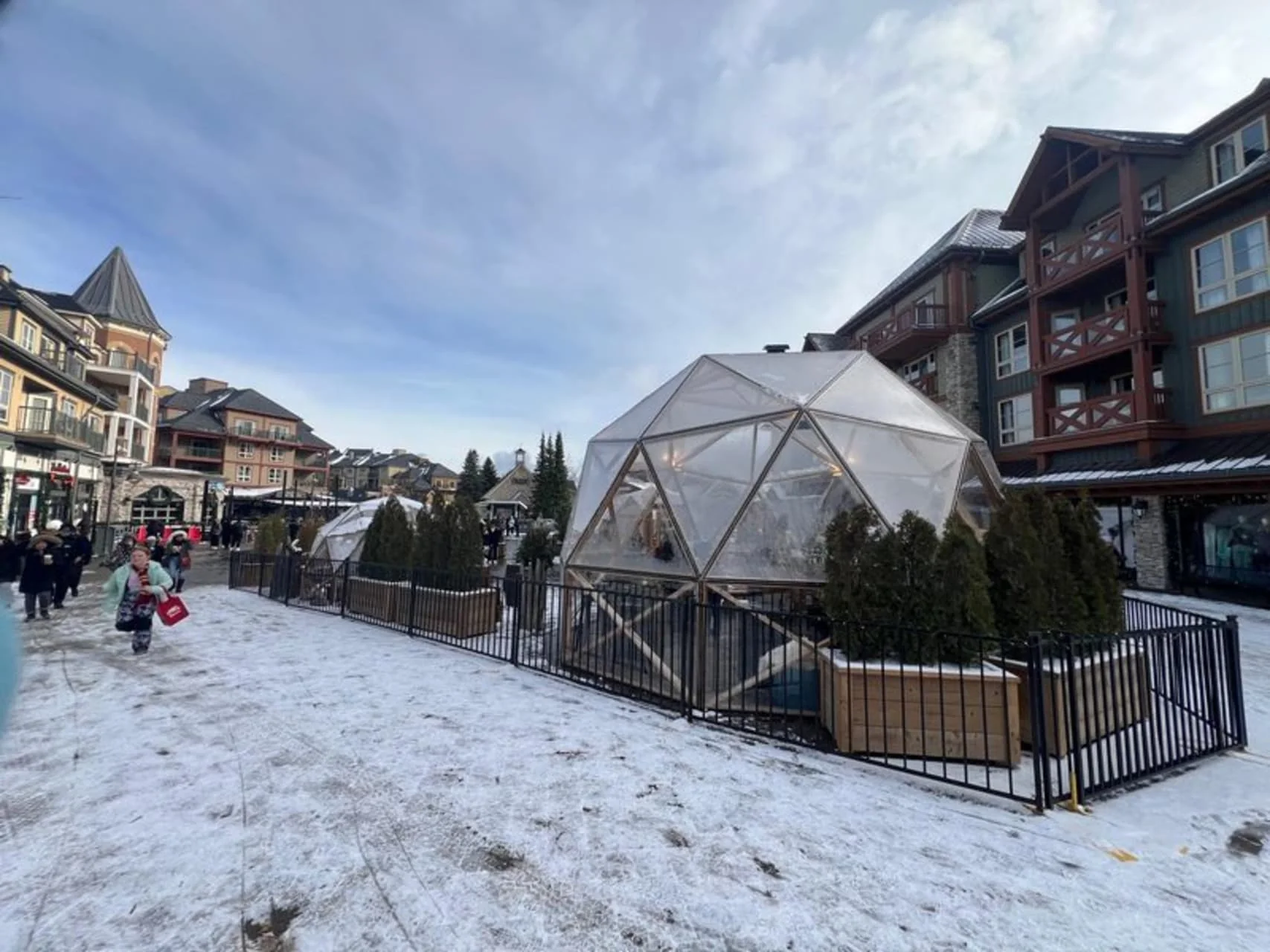 Blue Mountain Village winter scene with igloo patios and visitors