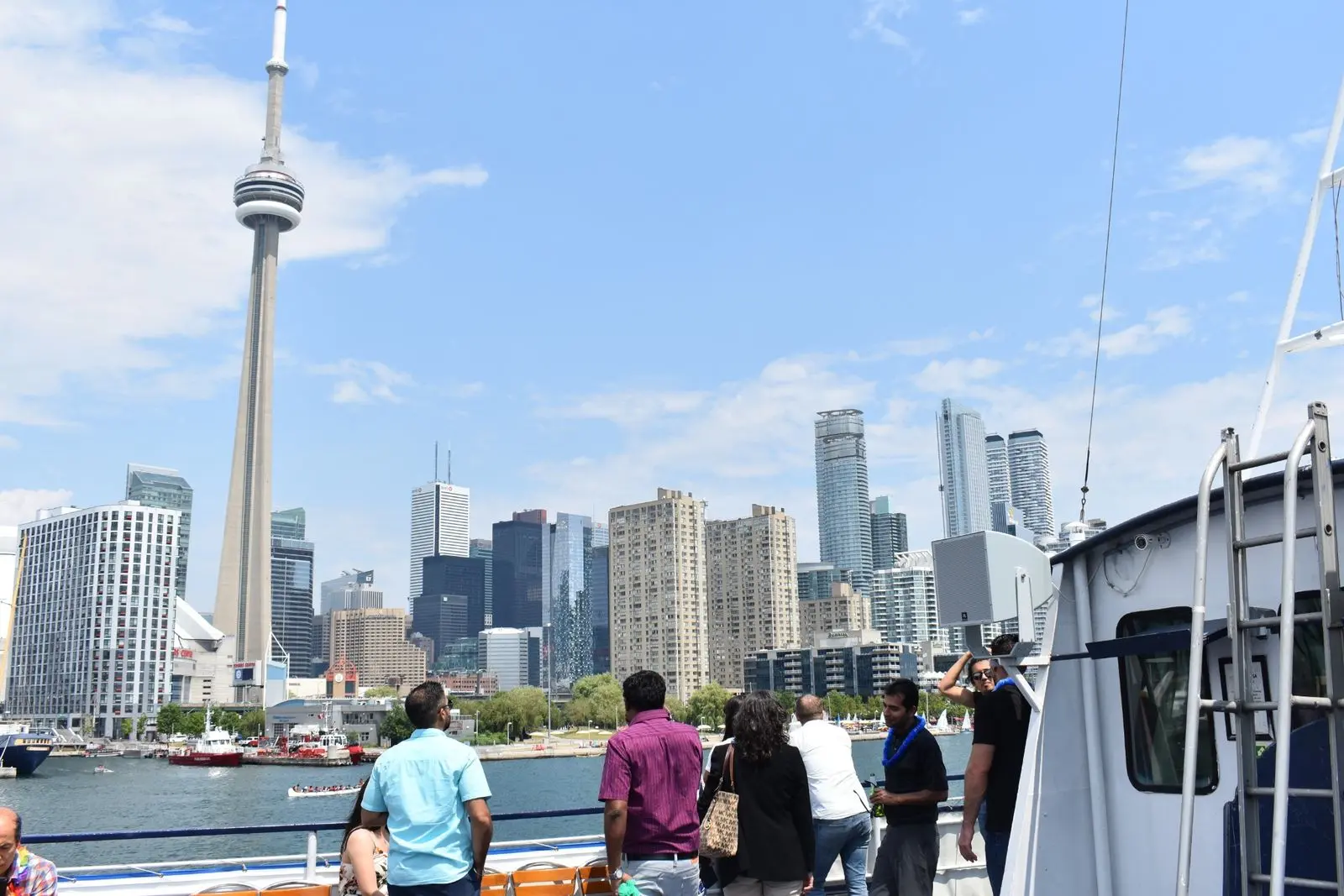 Guests enjoying Toronto harbour cruise with CN Tower skyline