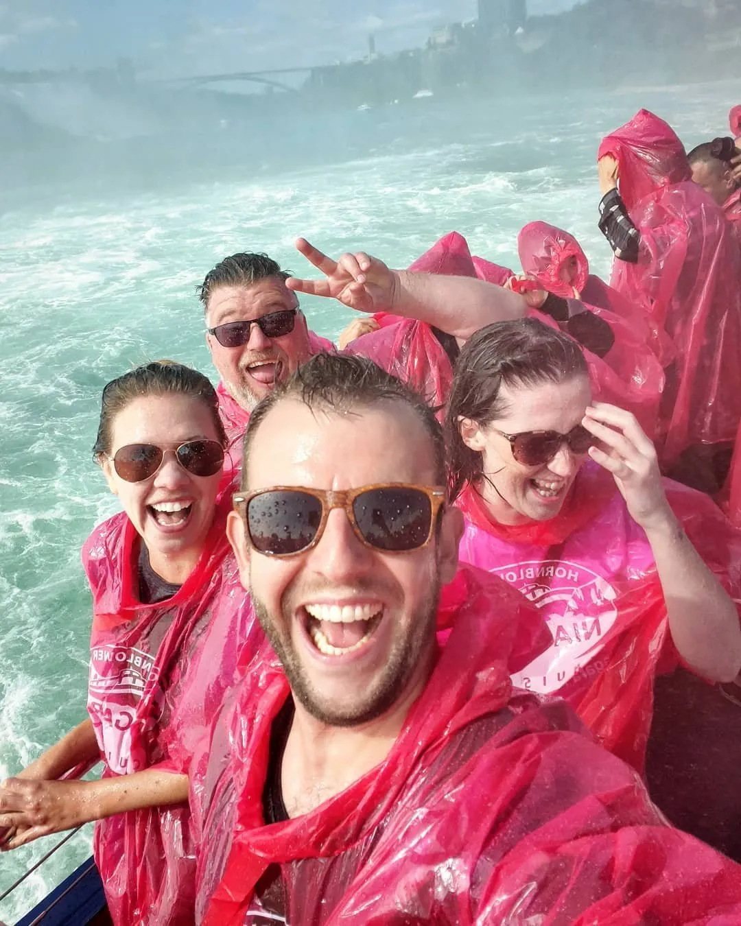 Tourists taking selfies during Niagara Falls boat tour experience