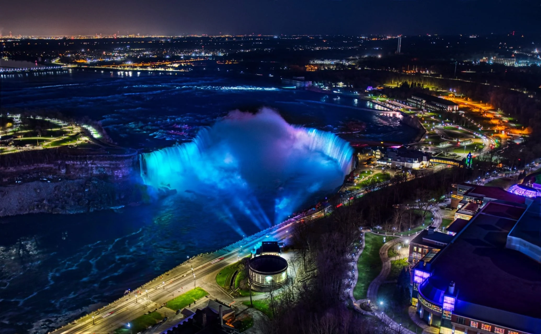 Niagara Falls tower and skyline illuminated with colorful lights during winter festival