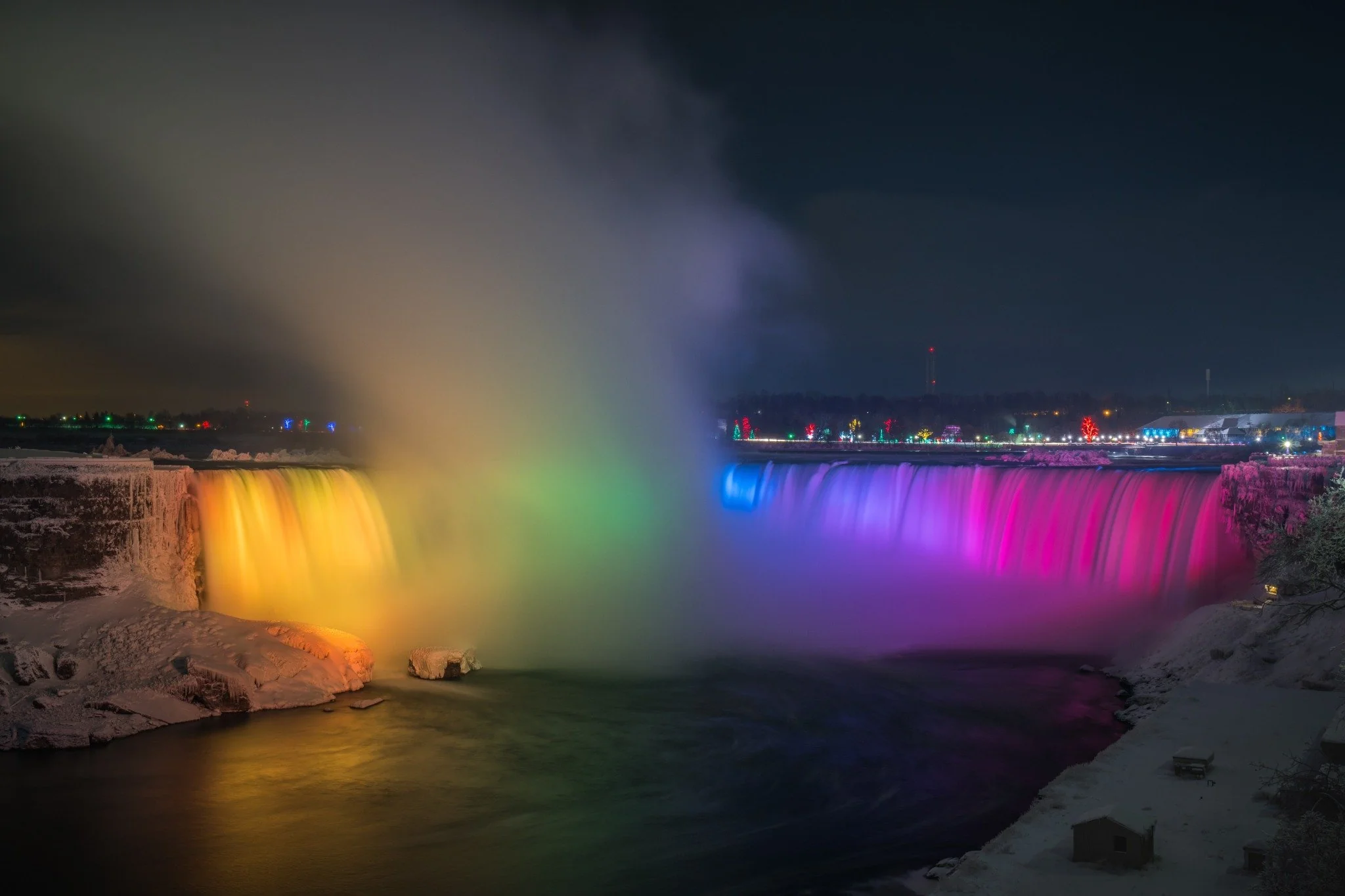 Rainbow colored winter illumination at Niagara Falls with spectacular light display