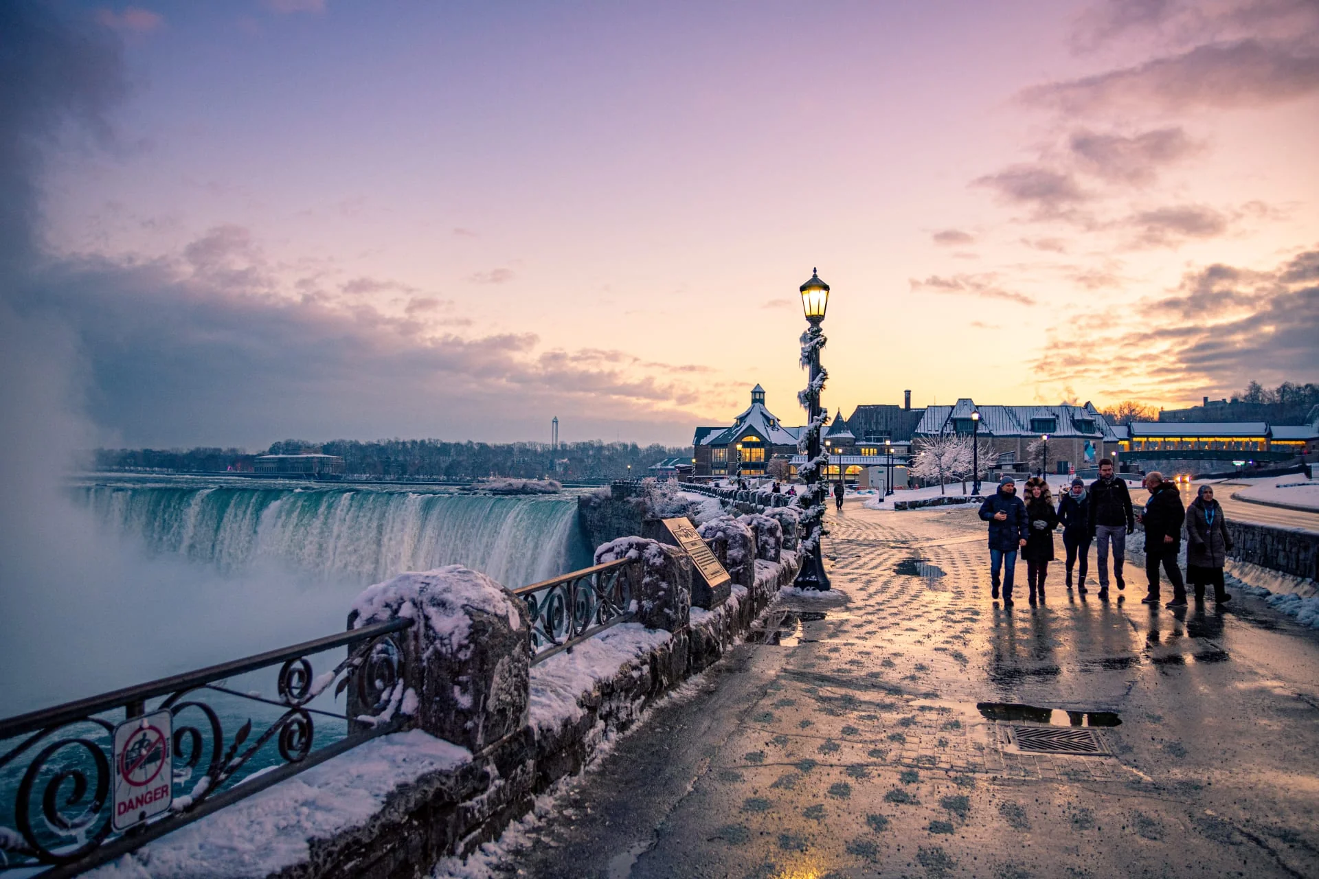 Wide panoramic winter view of frozen Niagara Falls from Table Rock Centre with snow and ice formations