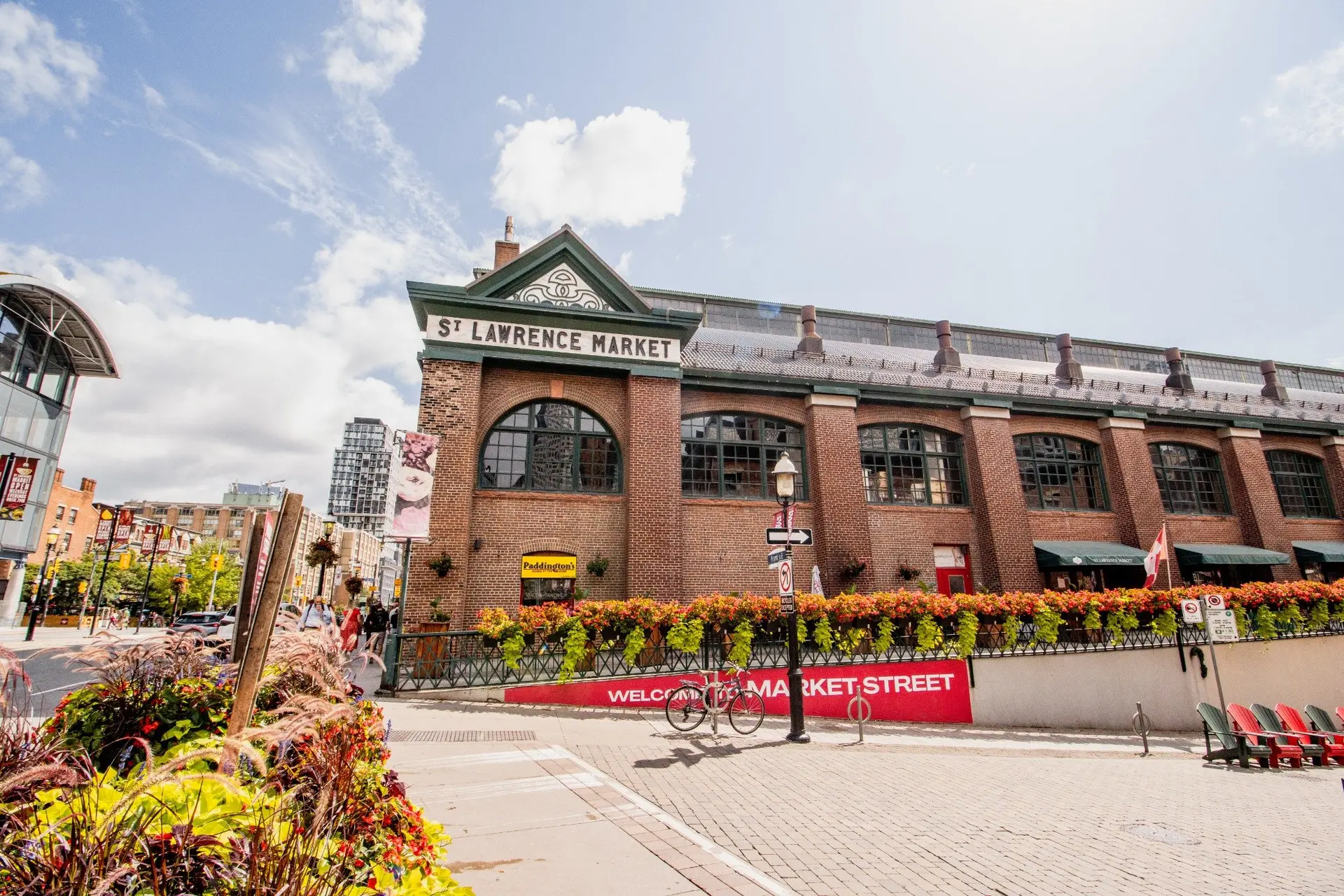 St. Lawrence Market exterior with vibrant flowers and signage