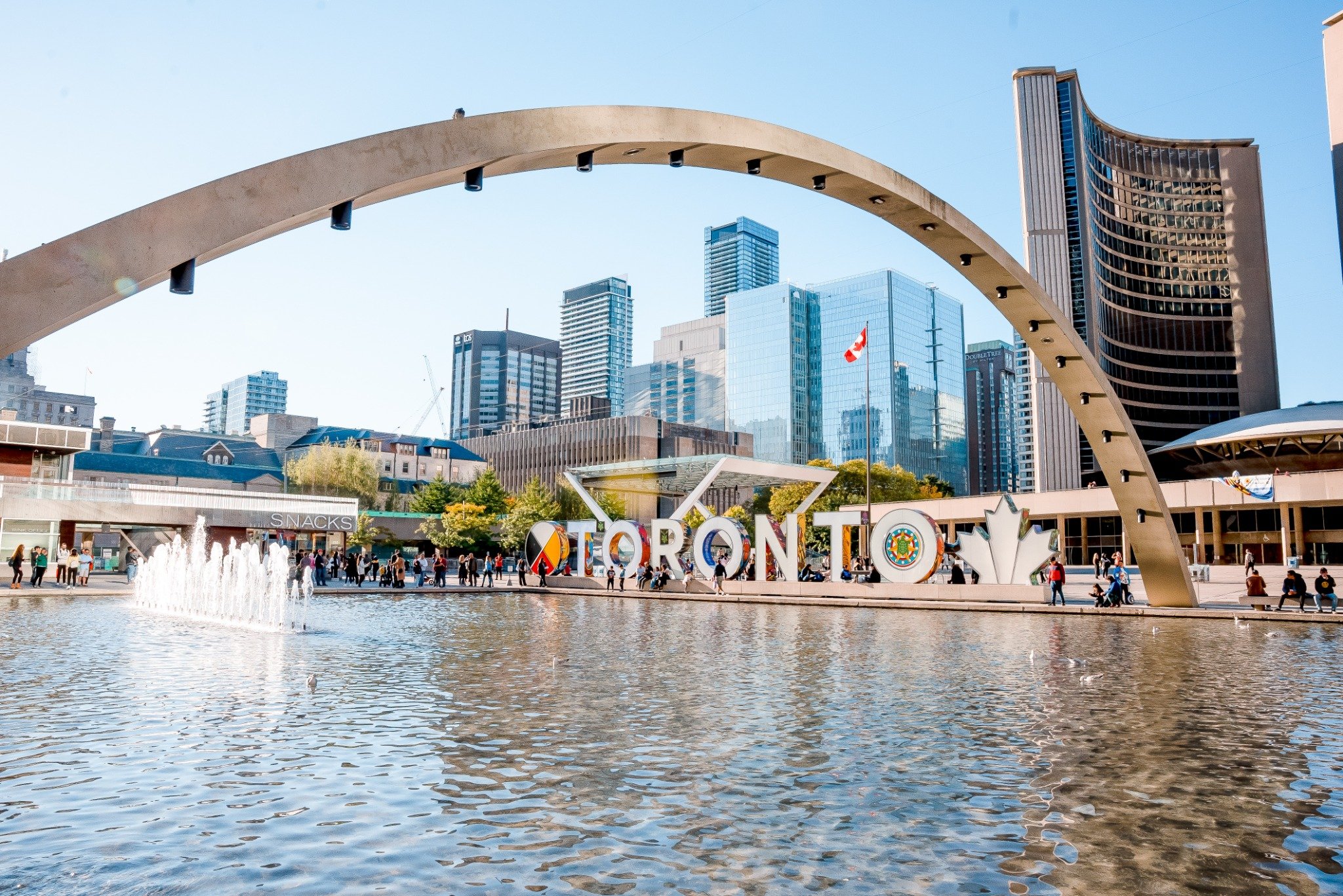 Toronto City Hall with iconic Toronto sign at Nathan Phillips Square